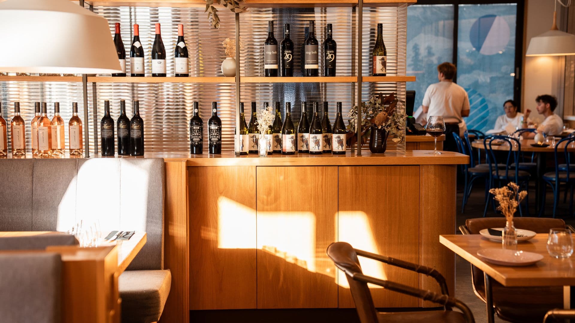Earl's wine bar and dining room in warm afternoon light, with guests seated